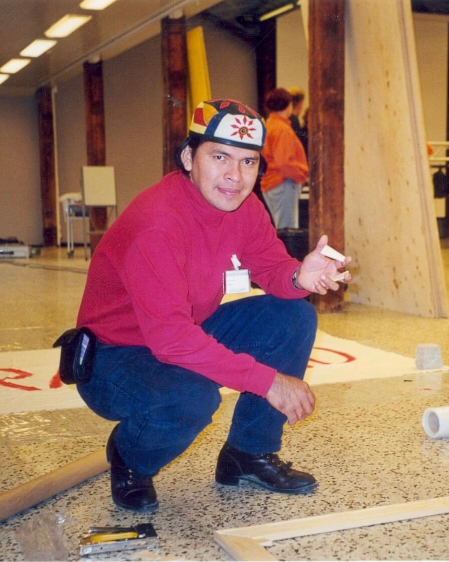 Anderson Debernardi kneeling down with a piece of paper in front of him.