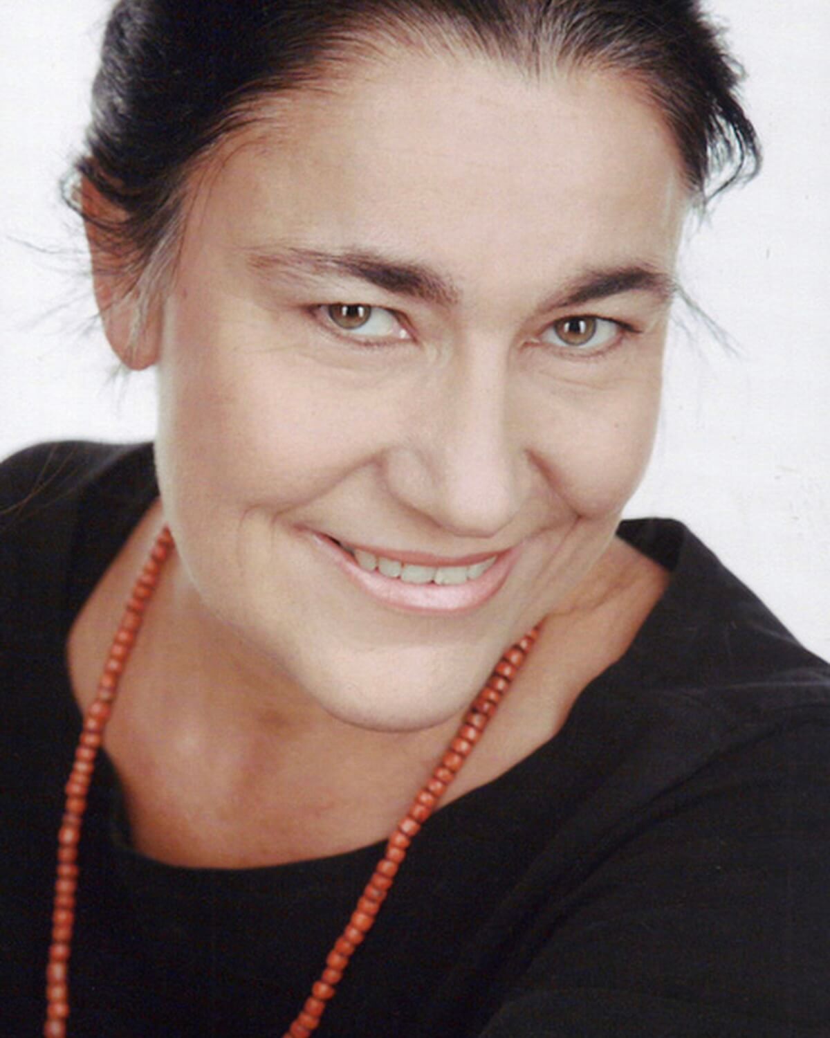 Dr. Claudia Mueller-Ebeling wearing a black shirt and a necklace.