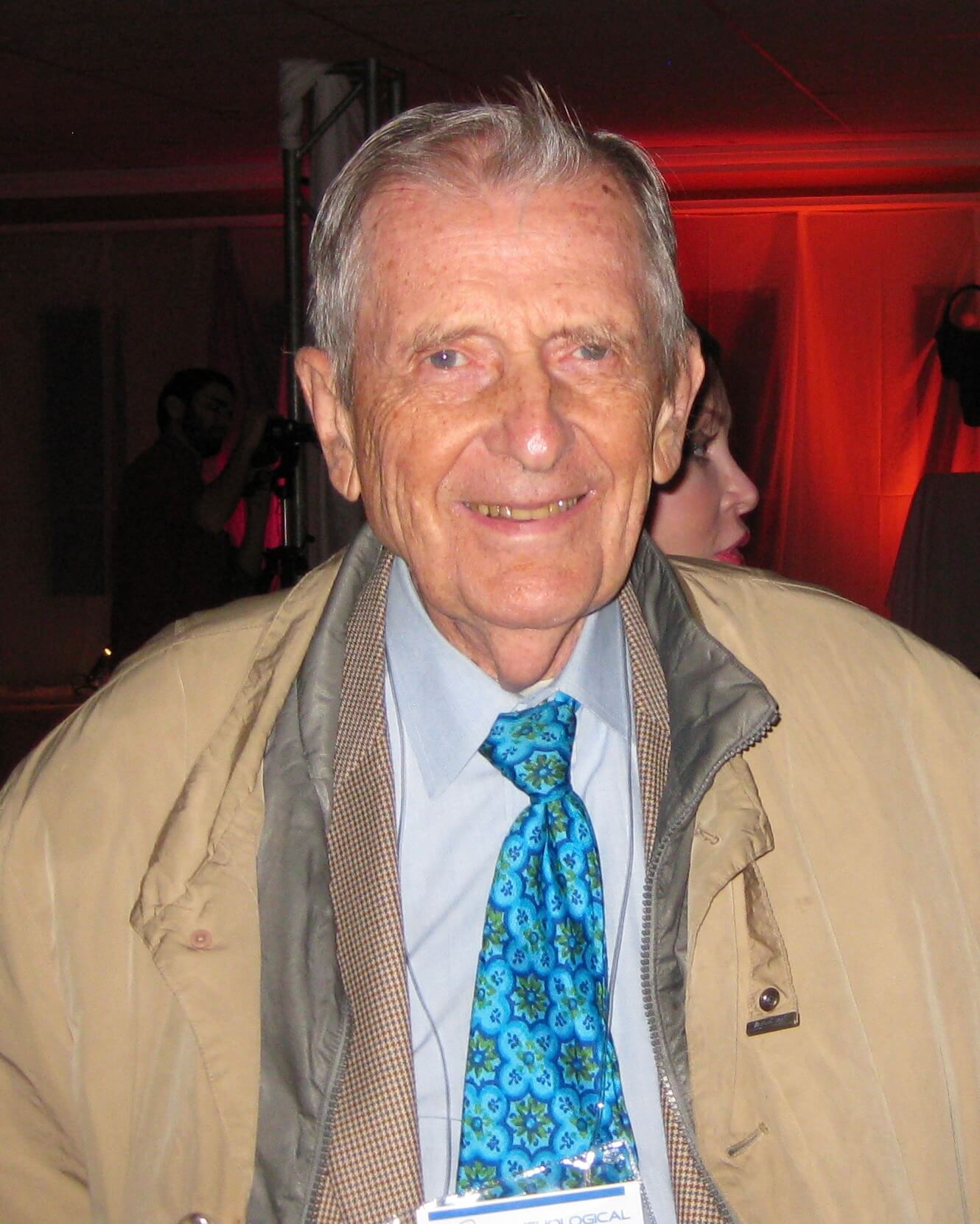 Dr. Stanley Krippner wearing a tan jacket.